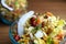 Spicy puffed rice, popular Indian street food, garnished with coconut slice, peanuts, tomato and coriander in a glass bowl