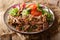 spicy pulled beef with vegetable salad close-up on a table. horizontal