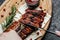 Spicy rack of spare ribs with BBQ sauce served on wood chopping board, Restaurant menu, dieting, cookbook recipe top