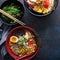 Spicy ramen bowls with noodles, pork and chicken