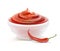 Spicy red sauce in white sauce-dish with chilli.