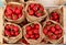 Spicy round chili peppers from Calabria in brown paper bags at the market