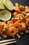 Spicy sauteed of shrimp, peanuts, lime and herbs closeup. vertical