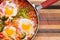 Spicy shakshuka with broccoli in a pan