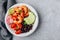 Spicy Shrimp Burrito Buddha Bowl with wild rice, tomatoes and radish, black beans and avocado