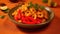 Spicy shrimp curry with red peppers served in a dark bowl with a warm-colored backdrop