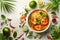 Spicy Shrimp Tom Yum Soup with Noodles Surrounded by Fresh Ingredients on White Background
