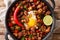 Spicy and sizzling pork sisig is a favorite for Filipinos close-up in a pan. Horizontal top view