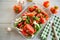 Spicy snack tomatoes with garlic, herbs, seasonings and onions in a glass bowl .