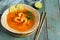 Spicy and Soup Curry with Shrimp.Wooden rustic green background.Selective focus