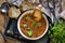 Spicy soup Kharcho on wooden background