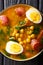 Spicy soup with spinach, chickpeas, chorizo sausages, boiled egg