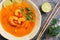 Spicy sour soup with prawns Tom Yum Goong on a rustic background. Thai food. View from above, flat lay
