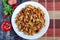 Spicy spaghetti with tomato paste on white plate divided background