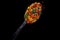 spicy spice with pieces dry vegetable in spoon condiments on black background generative ai