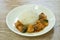 Spicy stir fried bass fish with white finger root and chili with rice on plate