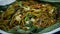 Spicy stir fried noodles with veggies and assortment of asian sauces served close up and called mie kenyol in indonesia