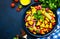 Spicy summer salad with sweet corn, red beans, avocado, jalapeno, red tomatoes, onion and fresh cilantro. Blue table background,