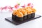 Spicy sushi roll on a stone plate