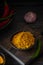 Spicy Svan salt in a black bowl on a dark wooden board on a black wooden background. Recipes for spices, spicy salt