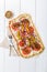 Spicy tarte flambee with pepperoni and olives