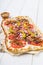 Spicy tarte flambee with pepperoni and olives