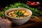 Spicy Thai soup with shrimp in a black bowl on a dark background. Tom Yum kung, traditional thai soup