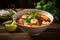 Spicy Thai soup with shrimp in a black bowl on a dark background. Tom Yum kung, traditional thai soup