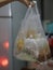 Spicy TOM YAM pork noodle soup with lemongrass, chilly pasted and lime juice in plastic clear bag, Thai food take home