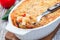 Spicy tomato jalapeno mac and cheese with mini penne pasta, in a baking dish, closeup, horizontal