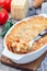 Spicy tomato jalapeno mac and cheese with mini penne pasta, in a baking dish, closeup, vertical