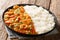 Spicy traditional shrimp Etouffee with celery, onion and pepper with sauce served with rice closeup in a plate. horizontal