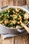 Spicy vegetarian chickpeas with spinach and mushrooms closeup on