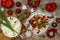 Spicy veggies tacos with roasted cauliflower, zucchini and tomato salsa on rustic wooden cutting board.