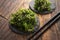 Spicy wakame salad on wooden background