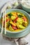 Spicy yellow curry with kaffir leaves, coconut milk and chicken