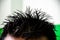 Spike hairstyle of a young man. Closeup of a spiky hairstyle of student using hard hair gel