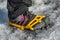 Spikes to walk on glacier ice stuck to woman`s foot