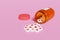 Spilled hearts pills next to a pill bottle isolated on a pink background. Concept of addiction to social media. 3d illustration