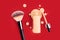 Spilled liquid foundation. Mockup glass bottle of correction cosmetic product with pipette and brush for make up on red background