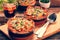 Spinach casserole bake with cheese and tomato on wooden background