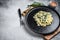 Spinach and Feta orzo pasta on a plate. White background. Top view. Copy space