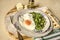 Spinach with fried eggs and sheep cheese,pita on striped chopping board