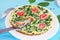 Spinach frittata ,italian omelet with cherry tomatoes in a white plate on a blue background. Healthy food conception