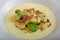 Spinach gnocchi with parmesan sauce topped with bacon