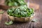 Spinach leaves.Fresh spinach leaves in retro bowl on oak wood board.