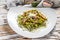 Spinach pasta with seafood, Green fettuccine on a plate. White background. Top view