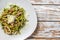 Spinach pasta with seafood, Green fettuccine on a plate. White background. Top view. Copy space