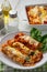 Spinach and ricotta stuffed cannelloni baked  in tomato sauce.