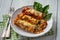 Spinach and ricotta stuffed cannelloni baked  in tomato sauce.